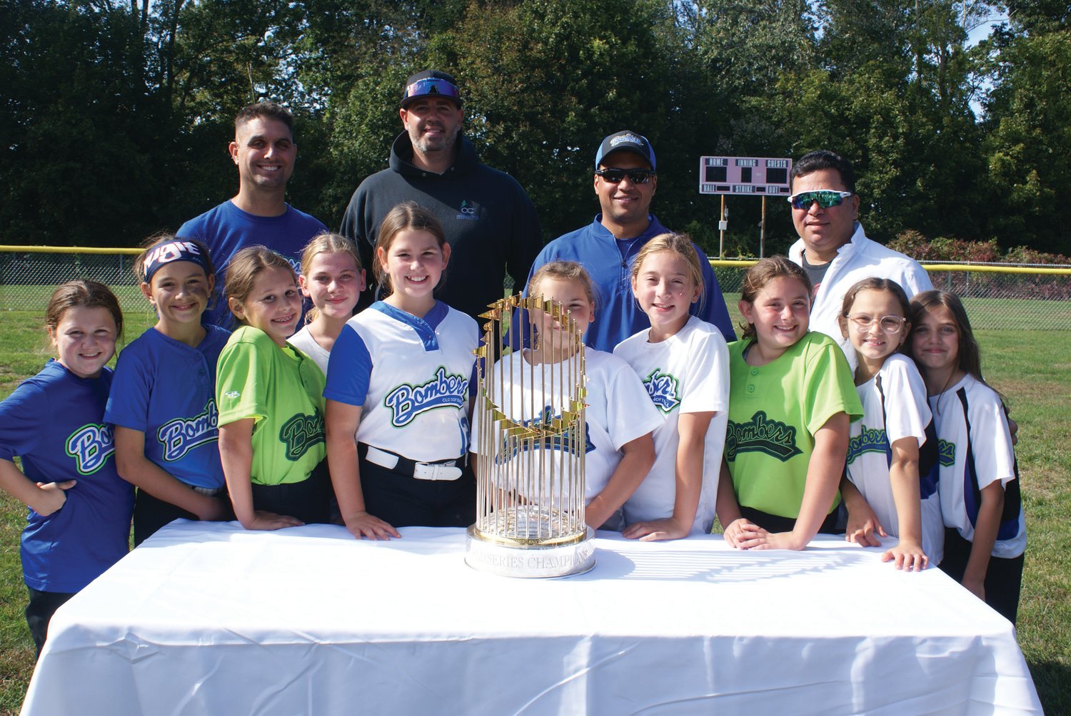 FOR THE TEAM: Pictured with the 2018 World Series trophy at Brayton Field are
coaches and players from the CLCF Bomber’s Travel Team (10 U).